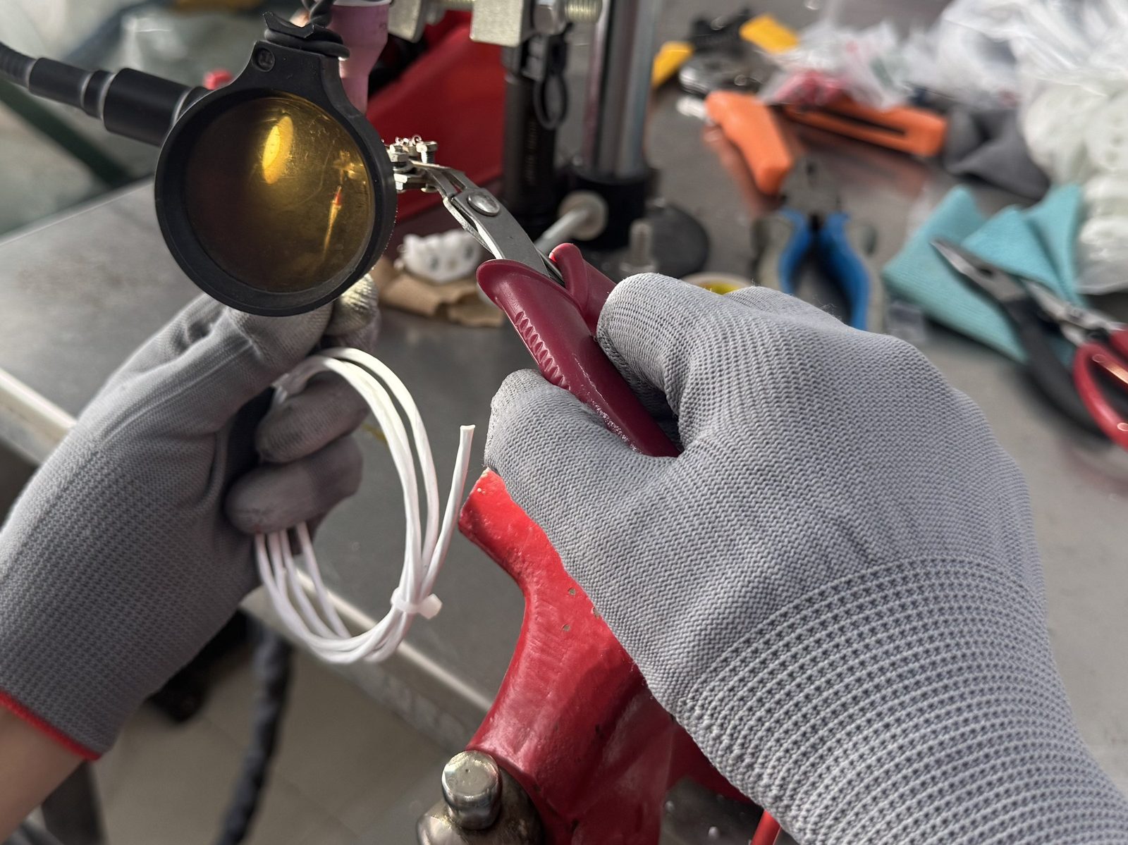 Technician assembling and checking the terminal head of a thermocouple by hand