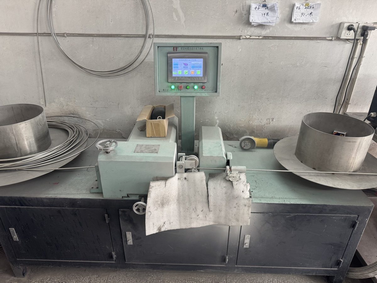 Armored thermocouple cable being measured and cut on the production line at the Yuyao factory
